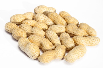 Unpeeled peanuts on a white background