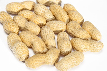 Untreated peanuts close-up on white background