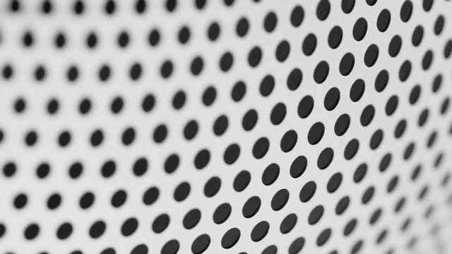 Rotated perforated steel surface background.