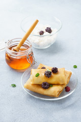 Stuffed crepes with honey, blackberries and mint.