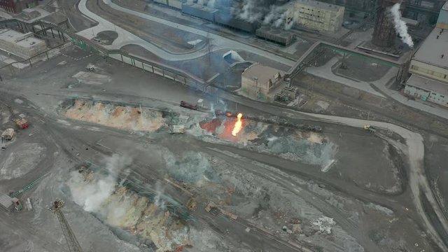 Pour molten slag from the diesel locomotive tank at a metallurgical plant. Aerial view