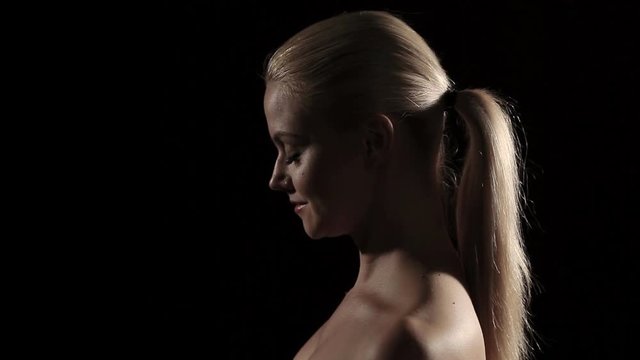 Portrait of a young woman in profile. Dynamic light