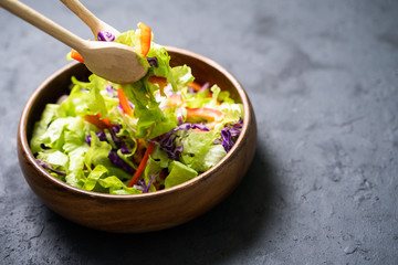 Luxurious fresh colorful vegetable salad isolated on black background.