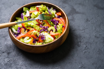 Luxurious fresh colorful vegetable salad isolated on black background.