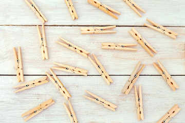 Wooden clothes pegs on wooden background. Zero waste