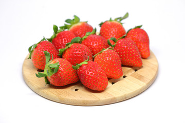 red strawberry on wooden plate