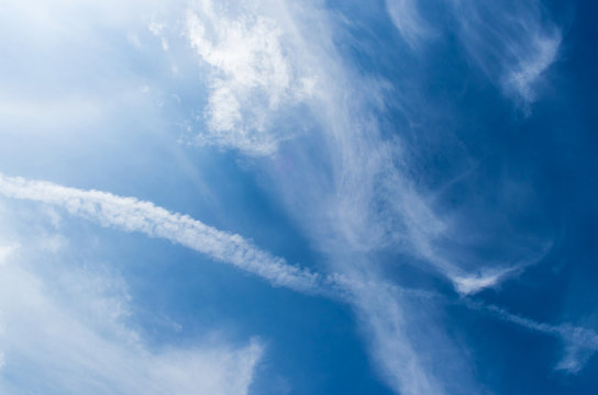 White clouds like fog in a bright blue sky