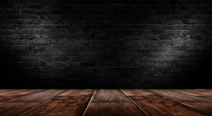 background of an empty black room, a cellar, lit by a searchlight. Brick black wall and wooden floor