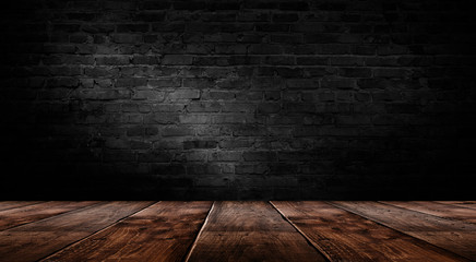 background of an empty black room, a cellar, lit by a searchlight. Brick black wall and wooden floor