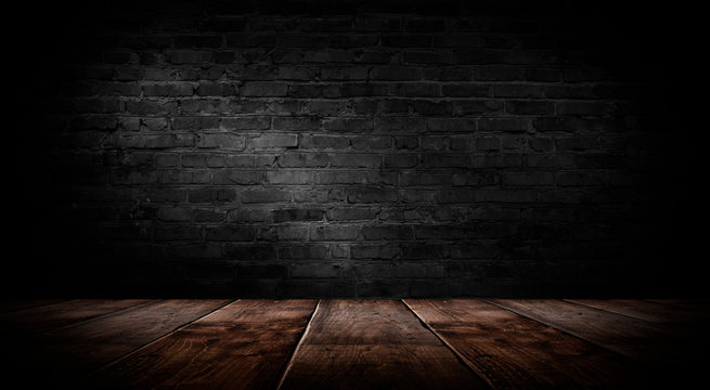 background of an empty black room, a cellar, lit by a searchlight. Brick black wall and wooden floor