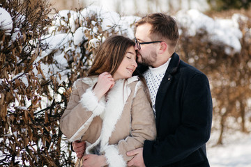 Young Beautiful Couple Taking Fun and Smiling Outdoors in Snowy Winter