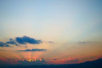 light rays of sun above clear blue sky