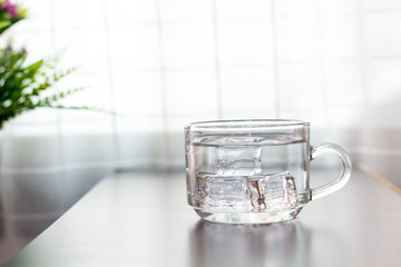 Glass of water on the table background