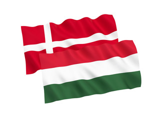 National fabric flags of Hungary and Denmark isolated on white background. 3d rendering illustration. 1 to 2 proportion.