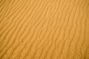 Sand of a beach with wave patterns