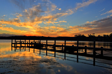Fototapeta na wymiar Beautiful sunset and timber jetty silhouette