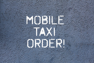 Fototapeta na wymiar Text sign showing Mobile Taxi Order. Conceptual photo type of vehicle for hire with driver used by passengers Brick Wall art like Graffiti motivational call written on the wall