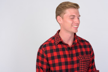 Happy young handsome hipster man relaxing with eyes closed