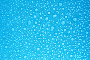 Naklejka na ściany i meble closeup drops water on blue background