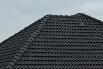 rain storm downpour on black roof tile of residential house