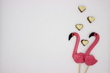 Lollipops in the form beautiful flamingo and chocolate hearts