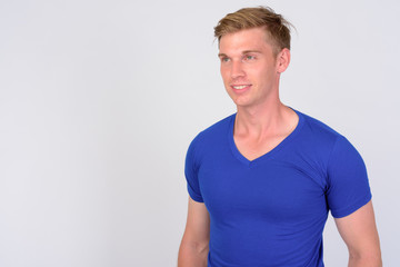 Fototapeta premium Happy young handsome man with blond hair thinking