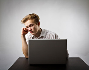 Young man with laptop. Overtime.