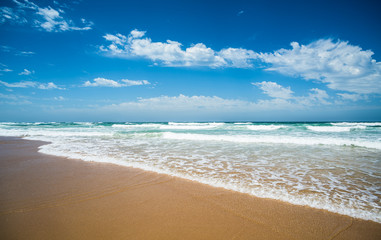 Fototapeta na wymiar Yellow sand beach, sea and deep blue sky.