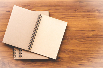 Notebook mock up design template isolated on wooden table background.