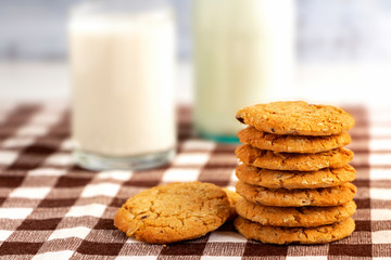 A bottle of milk and cookies made of oats on the wooden table. Copy space for your text or image.