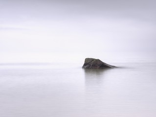 Impressive atmosphere of evening sea. Peaceful sea level with stones