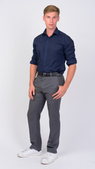 Fototapeta premium Full body shot of young handsome businessman with blond hair