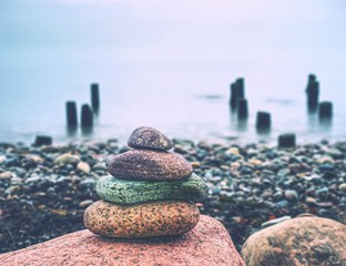 Stones pyramid symbolizing zen harmony balance pebbles. Peaceful ocean