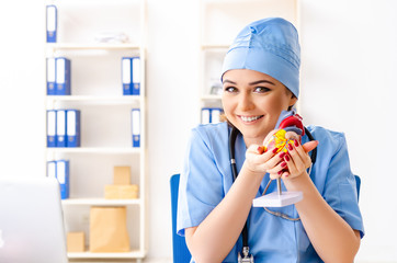 Young female doctor cardiologist sitting at the hospital