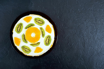 Fruit cake on a black background, copy space. Top view. Festive cake.