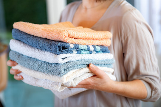 Woman carries towels