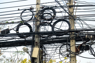 Messily Electric and Signal Wire on the Post in the Urban Area