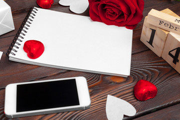 Valentine's day background. Empty blank notebook, gift box, flowers on a white background, top view. Free space for text