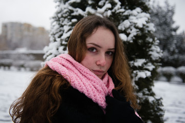 Portrait of a woman in a woolen scarf in winter outside