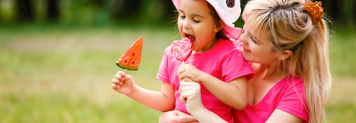 Mother and daughter with lollipops