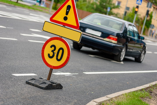 Road sign for 30 speed limit and danger traffic sign