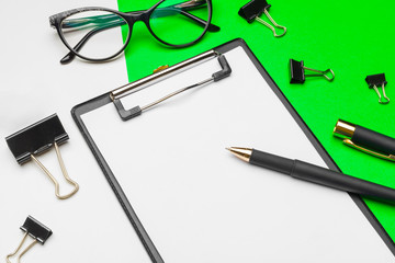 Blank clipboard paper on bright green paper background, copy space
