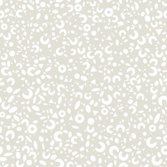 Abstract seamless monochrome pattern from simple white geometric shapes: circles, ovals, triangles, rings on gray background.