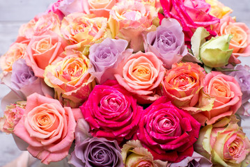 Beautiful bouquet of roses in a gift box. Bouquet of pink roses. Pink roses close-up. on wooden background, with space for text.