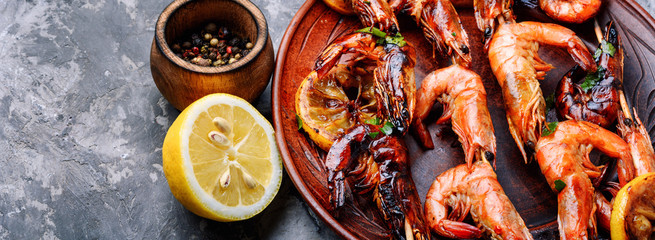 Grilled shrimps skewers with lemon