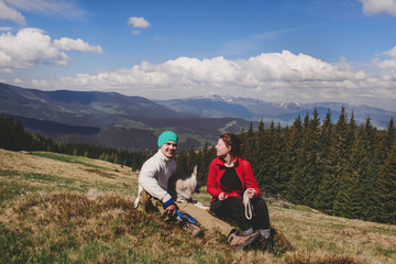 Fototapeta premium Guy and girl on top of the mountain