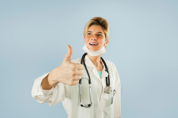 doctor girl shows thumb up on blue isolated background. Concept medicine and health