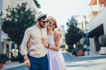 Happy young couple walking by touristic sea resort
