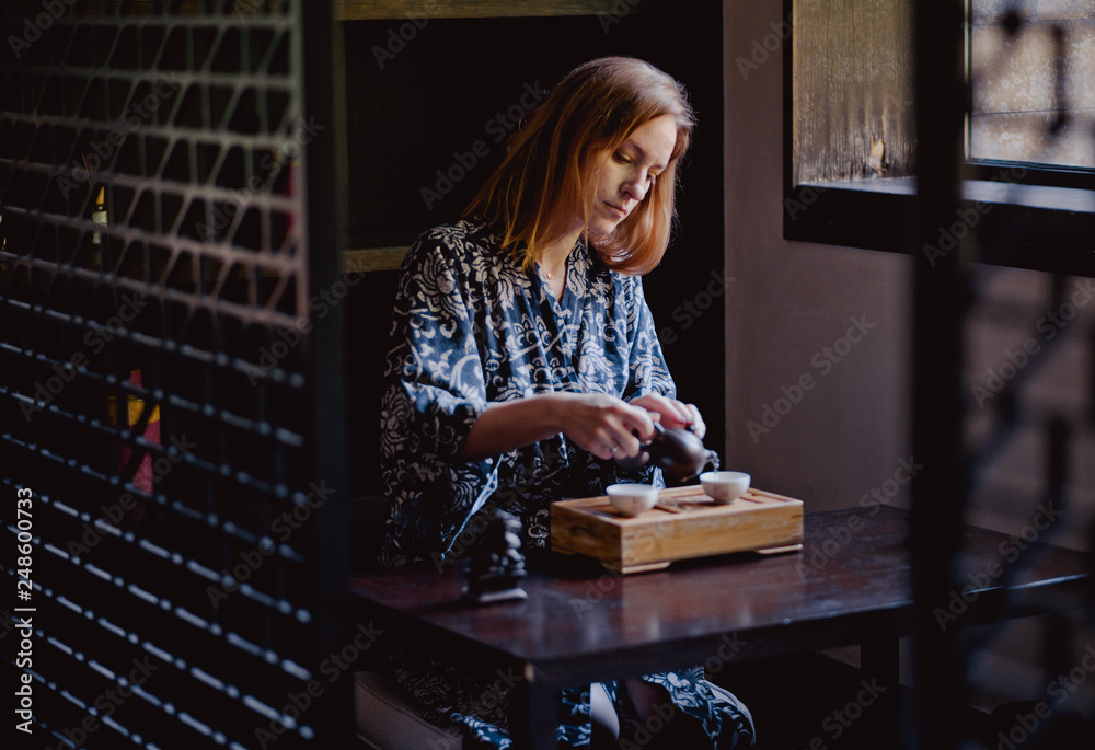 Wall mural young women making and drink chinese tea ceremony.