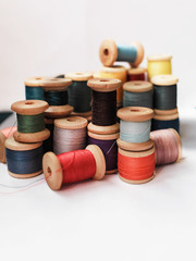 Sewing thread colored on white background